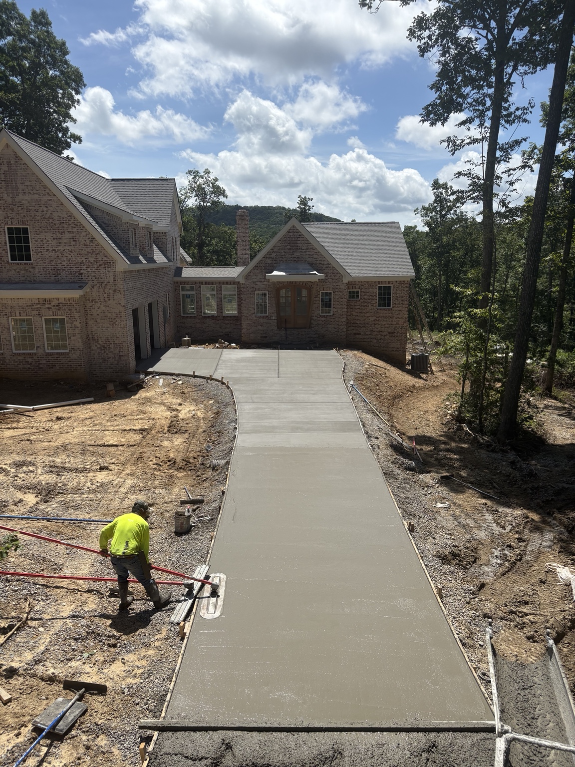 Finishing a freshly poured concrete driveway